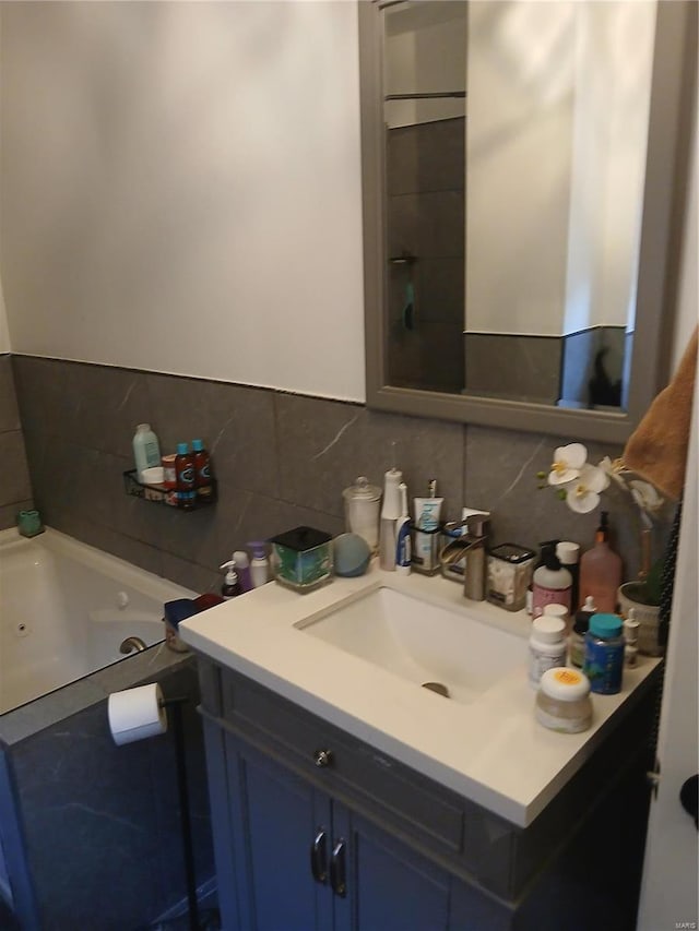 1018 N Hornsby, Saint Louis, MO 63147 - bathroom featuring backsplash, vanity, and a whirlpool tub