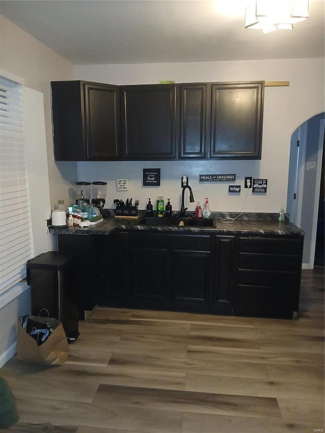 1018 N Hornsby, Saint Louis, MO 63147 - kitchen featuring dark countertops, a sink, and light wood-style floors