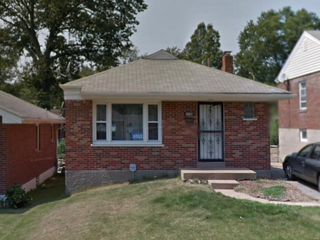 4709 Fletcher St, Saint Louis, MO 63121 - bungalow-style house with a chimney, brick siding, and a front yard
