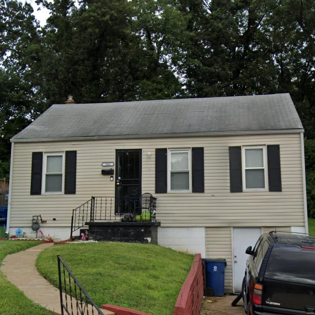 506 Averill Ave, Saint Louis, MO 63135 - view of front of house featuring an attached garage, a front lawn, and a shingled roof