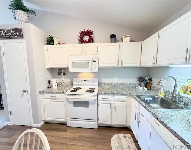 7507 Triwoods Dr Unit J, Saint Louis, MO 63119 - kitchen featuring white appliances, a sink, dark wood-style floors, white cabinets, and vaulted ceiling