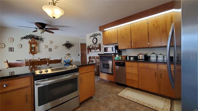 319 County Road 2270, Salem, MO 65560 - kitchen with appliances with stainless steel finishes, a ceiling fan, dark countertops, brown cabinets, and tile patterned floors