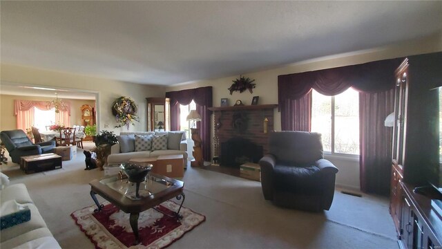 319 County Road 2270, Salem, MO 65560 - carpeted living room featuring plenty of natural light, a chandelier, and a fireplace