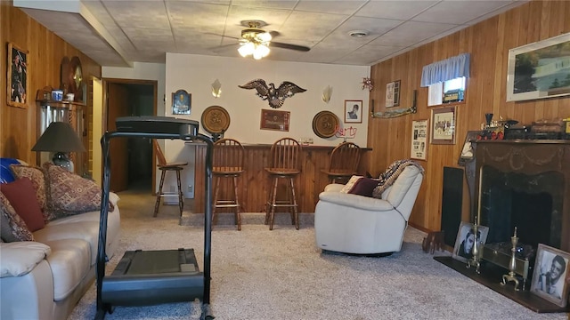 319 County Road 2270, Salem, MO 65560 - carpeted living area with wood walls, a ceiling fan, and a dry bar