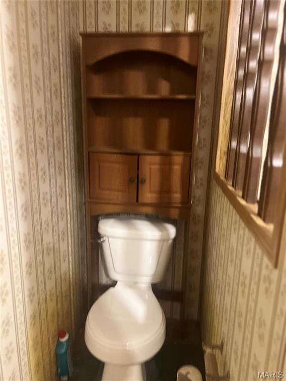 bathroom with wallpapered walls and toilet