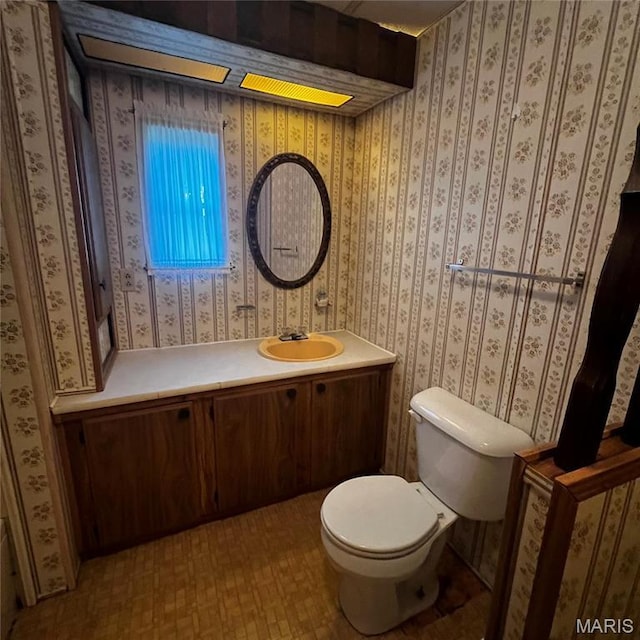 bathroom featuring toilet and vanity