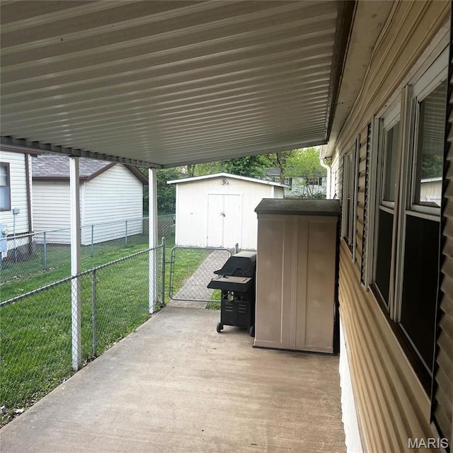 view of patio with a storage unit, an outbuilding, and a grill
