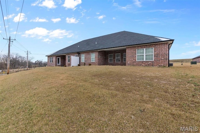 4 Creekside Way, Cape Girardeau, MO 63701 - back of property with a lawn, brick siding, and a shingled roof
