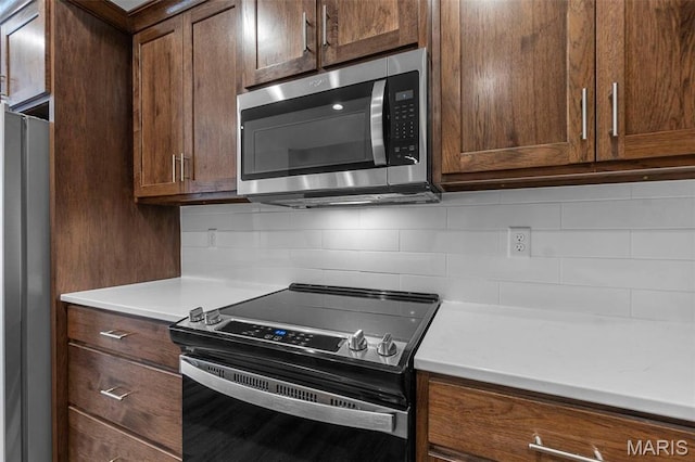 4 Creekside Way, Cape Girardeau, MO 63701 - kitchen with appliances with stainless steel finishes, decorative backsplash, and light countertops