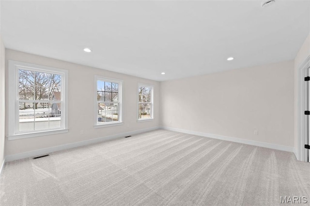 629 Simmons Ave, Saint Louis, MO 63122 - empty room with healthy amount of natural light, light carpet, baseboards, and recessed lighting