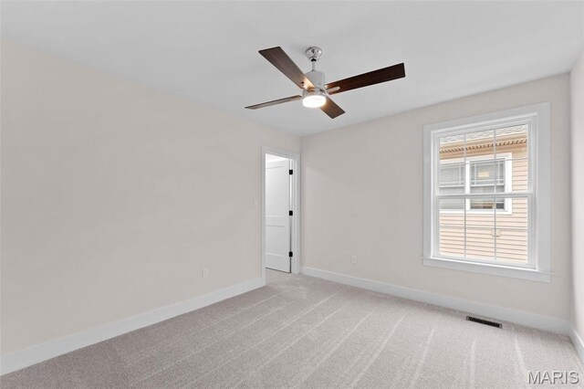 629 Simmons Ave, Saint Louis, MO 63122 - unfurnished room with baseboards, ceiling fan, and light carpet