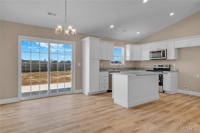 8 Bluebell Way, Jackson, MO 63755 - kitchen featuring appliances with stainless steel finishes, white cabinets, a chandelier, vaulted ceiling, and decorative light fixtures