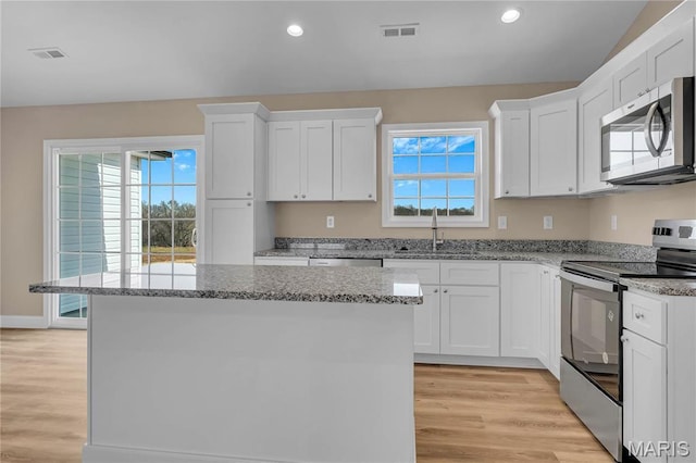 8 Bluebell Way, Jackson, MO 63755 - kitchen featuring stainless steel appliances, a sink, a kitchen island, white cabinets, and light stone counters