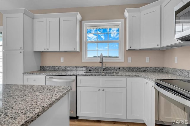 8 Bluebell Way, Jackson, MO 63755 - kitchen with appliances with stainless steel finishes, a sink, white cabinets, and light stone counters