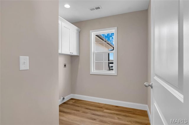 8 Bluebell Way, Jackson, MO 63755 - laundry room featuring electric dryer hookup, baseboards, cabinet space, and light wood finished floors
