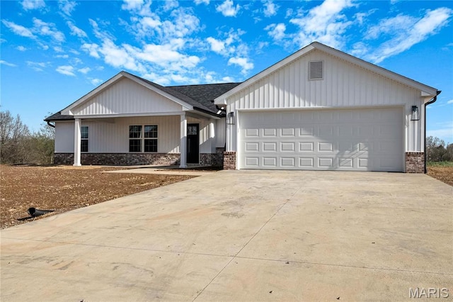 8 Bluebell Way, Jackson, MO 63755 - view of front of home featuring brick siding, concrete driveway, and covered porch