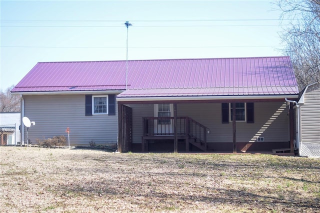 back of property featuring metal roof