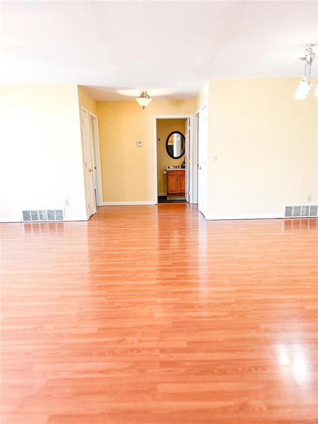 unfurnished living room with light wood-style floors and baseboards
