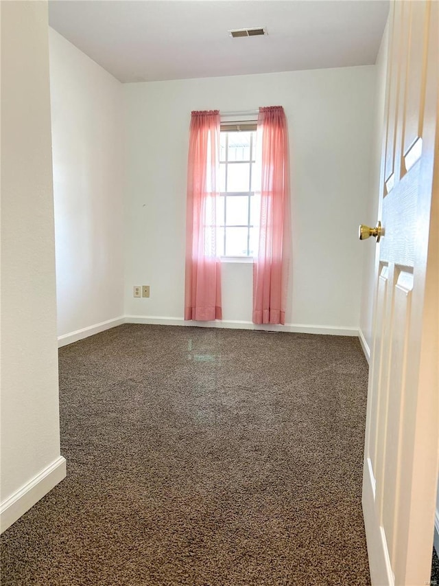 empty room with carpet and baseboards