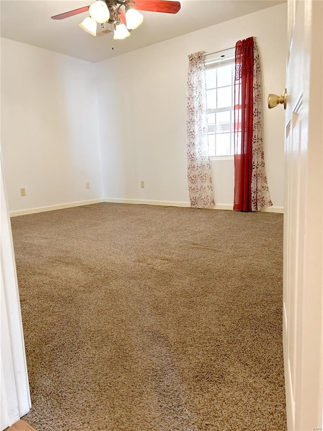 empty room featuring a ceiling fan, carpet flooring, and baseboards