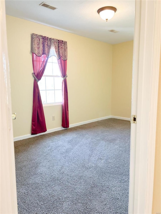empty room with carpet and baseboards