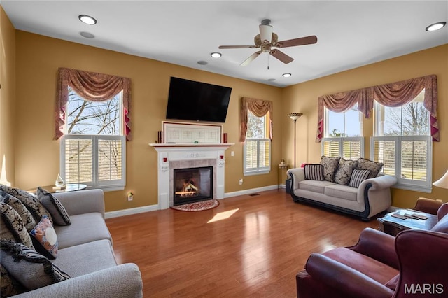 4349 Murdoch Ln, Augusta, MO 63332 - living area with ceiling fan, wood finished floors, baseboards, a tiled fireplace, and recessed lighting