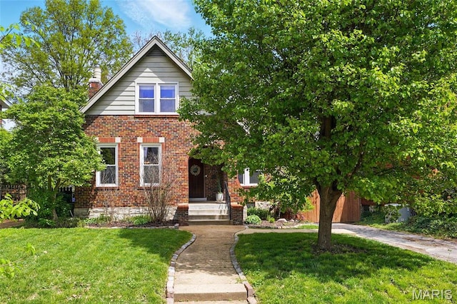 7335 Shaftesbury Ave, University City, MO 63130 - view of front of property with brick siding, a front yard, and a chimney