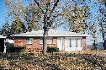 back of house featuring brick siding