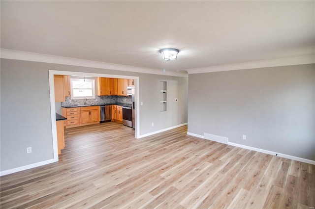 429 Oak St, East Alton, IL 62024 - unfurnished living room with a sink, baseboards, ornamental molding, and light wood-type flooring