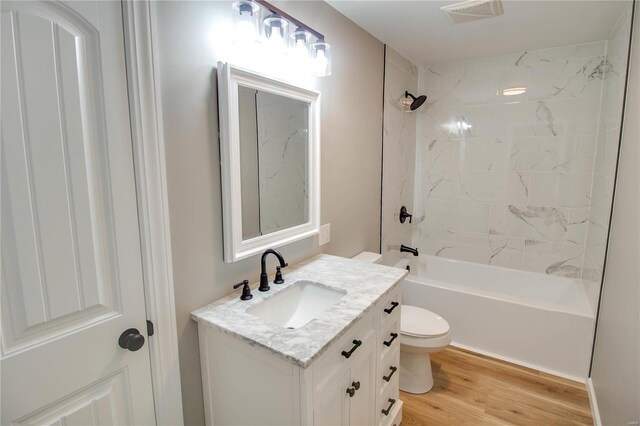 429 Oak St, East Alton, IL 62024 - bathroom featuring toilet, vanity, shower / bath combination, and wood finished floors