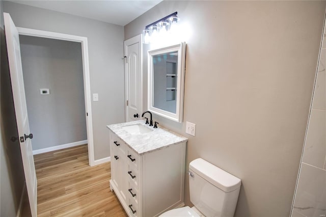 429 Oak St, East Alton, IL 62024 - half bath with wood finished floors, toilet, baseboards, and vanity