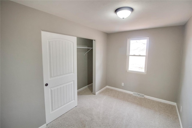 429 Oak St, East Alton, IL 62024 - unfurnished bedroom with carpet, baseboards, and a closet