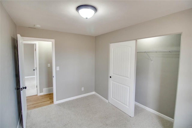 429 Oak St, East Alton, IL 62024 - unfurnished bedroom with carpet, a closet, and baseboards