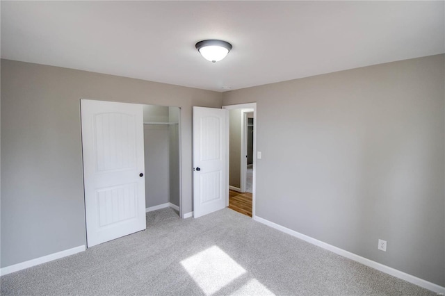 429 Oak St, East Alton, IL 62024 - unfurnished bedroom featuring a closet, carpet, and baseboards