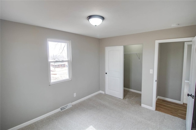 429 Oak St, East Alton, IL 62024 - unfurnished bedroom featuring carpet, a closet, and baseboards