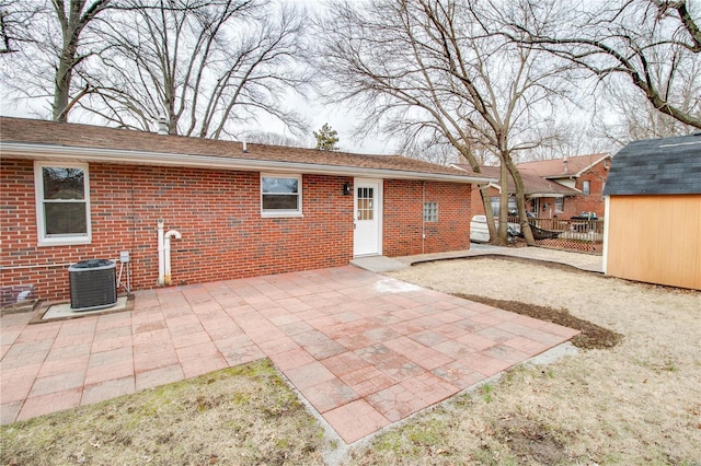 429 Oak St, East Alton, IL 62024 - rear view of house featuring brick siding, central air condition unit, an outbuilding, and a storage unit
