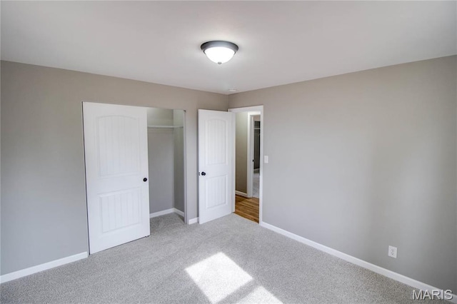 429 Oak St, East Alton, IL 62024 - unfurnished bedroom with a closet and carpet flooring