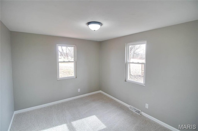 429 Oak St, East Alton, IL 62024 - spare room featuring plenty of natural light and carpet