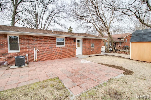429 Oak St, East Alton, IL 62024 - rear view of property featuring brick siding, a storage shed, and a patio area