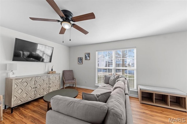 living area featuring wood finished floors and a ceiling fan