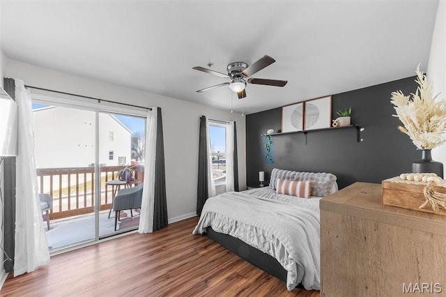 bedroom with access to outside, wood finished floors, baseboards, and ceiling fan