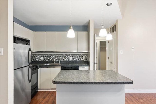 1052 S Kingshighway Blvd, Saint Louis, MO 63110 - kitchen featuring black appliances, dark countertops, a sink, dark wood finished floors, and tasteful backsplash
