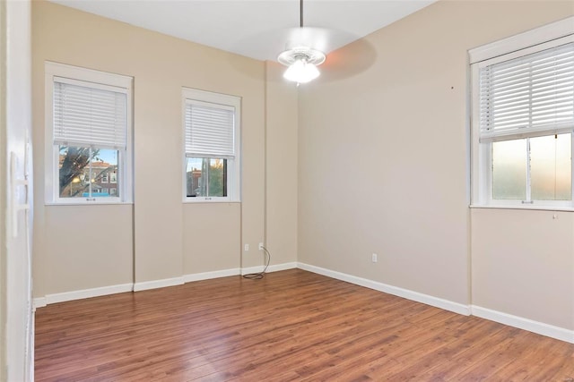1052 S Kingshighway Blvd, Saint Louis, MO 63110 - empty room with wood finished floors, a ceiling fan, and baseboards