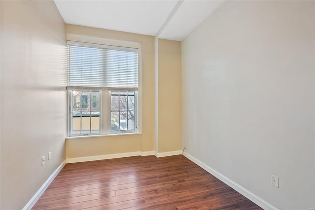 1052 S Kingshighway Blvd, Saint Louis, MO 63110 - spare room with wood finished floors, plenty of natural light, and baseboards