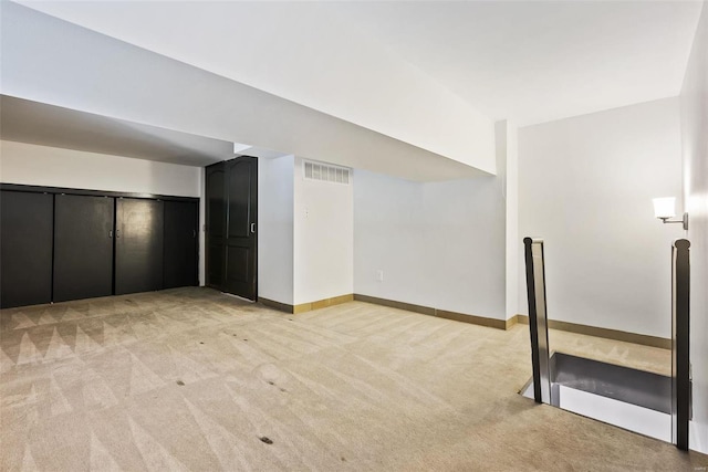 1052 S Kingshighway Blvd, Saint Louis, MO 63110 - unfurnished living room with light colored carpet and baseboards