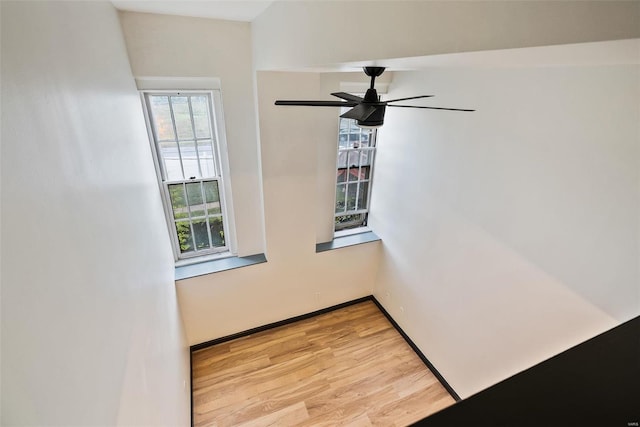 1052 S Kingshighway Blvd, Saint Louis, MO 63110 - spare room with light wood-style floors, a ceiling fan, and baseboards