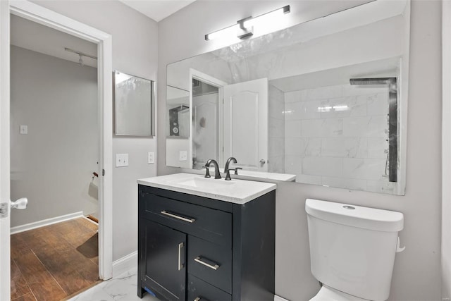 1052 S Kingshighway Blvd, Saint Louis, MO 63110 - bathroom with vanity, marble finish floors, toilet, and baseboards