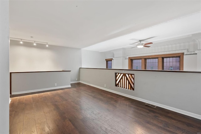 1052 S Kingshighway Blvd, Saint Louis, MO 63110 - unfurnished room with wood-type flooring, ceiling fan, rail lighting, and baseboards