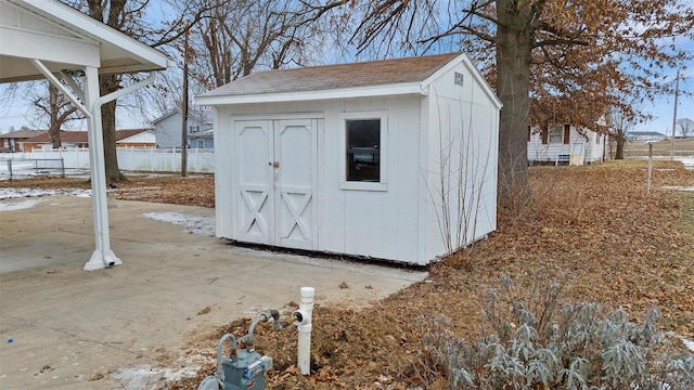 view of shed featuring fence