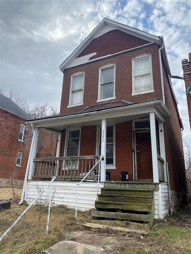 5232 Cote Brilliante Ave, Saint Louis, MO 63113 - view of front of home featuring brick siding, a porch, and fence